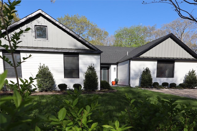 10 Hampton St, Westhampton Beach, NY 11978 - modern inspired farmhouse featuring board and batten siding, roof with shingles, and a front lawn