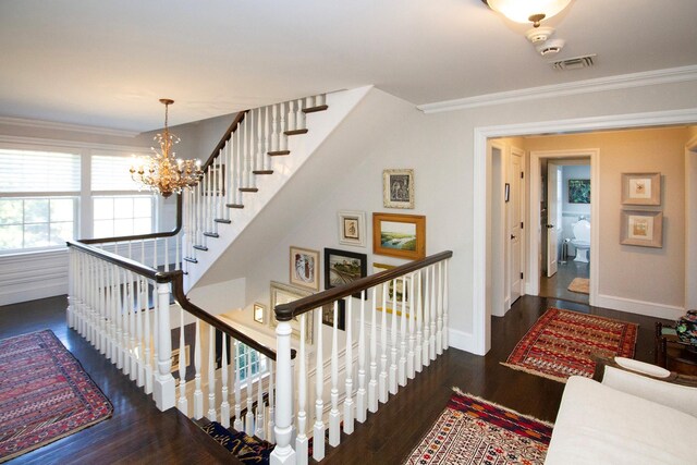 31 Paquatuck Ave, East Moriches, NY 11940 - stairs featuring ornamental molding, a notable chandelier, visible vents, and wood finished floors