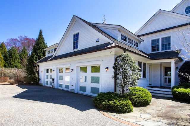 31 Paquatuck Ave, East Moriches, NY 11940 - view of property exterior featuring covered porch, aphalt driveway, and an attached garage