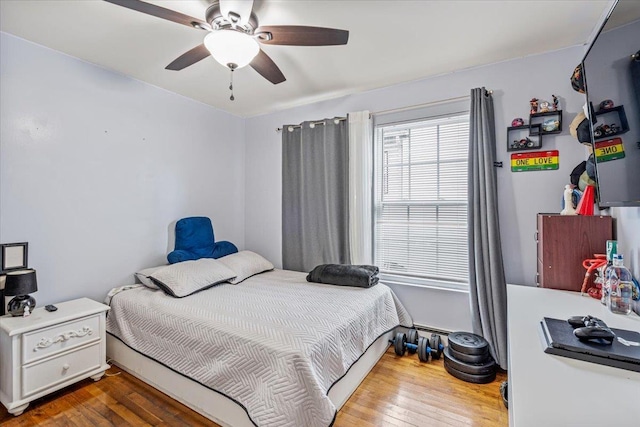 bedroom with hardwood / wood-style floors and a ceiling fan