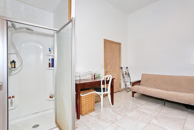 bathroom with a stall shower and a high ceiling