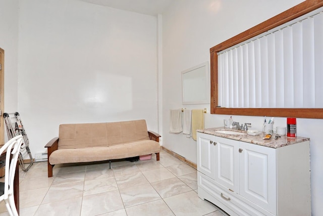 bathroom featuring baseboards, a baseboard heating unit, and vanity