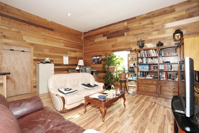 living room featuring wooden walls and light wood-style flooring