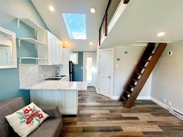 kitchen featuring white cabinets, open shelves, light stone countertops, and dark wood finished floors