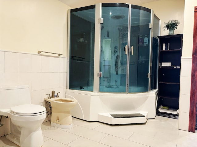 300 Ellen Pl, Oyster Bay, NY 11753 - bathroom featuring toilet, tile patterned floors, a wainscoted wall, tile walls, and a bidet