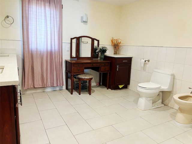 300 Ellen Pl, Oyster Bay, NY 11753 - bathroom featuring a bidet, tile walls, vanity, tile patterned floors, and toilet