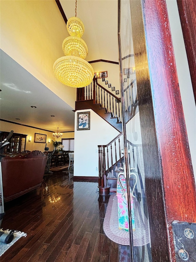 300 Ellen Pl, Oyster Bay, NY 11753 - stairway with baseboards, a high ceiling, a chandelier, and hardwood / wood-style flooring