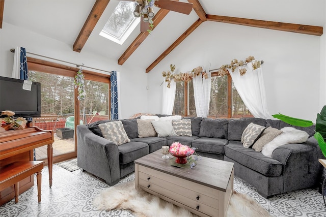 living room featuring high vaulted ceiling, a ceiling fan, beam ceiling, and a skylight
