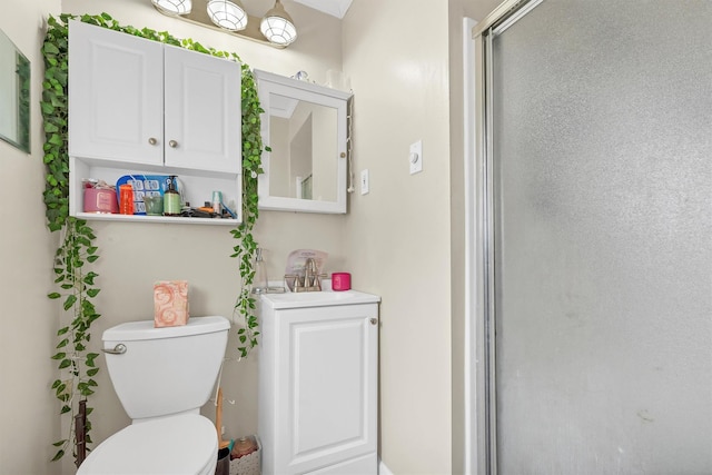 full bathroom with toilet, a shower with door, and a sink
