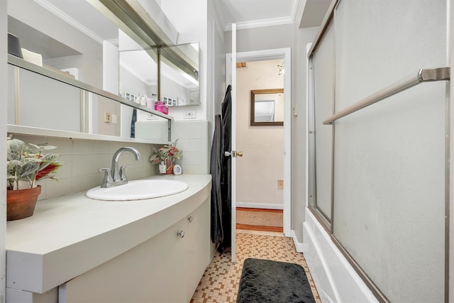 bathroom featuring tasteful backsplash, tile patterned floors, vanity, enclosed tub / shower combo, and ornamental molding