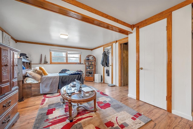 living area featuring light wood-style flooring and ornamental molding