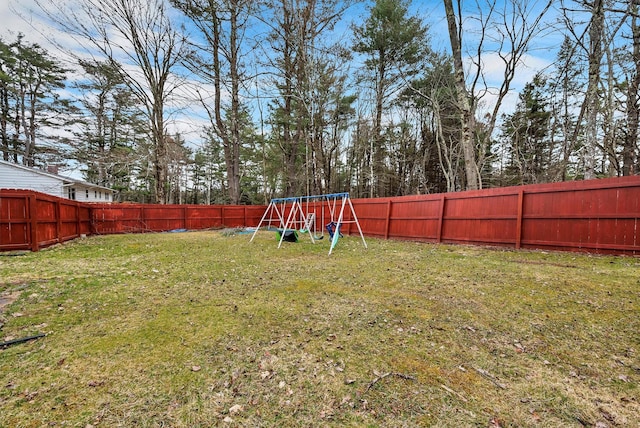 view of yard featuring a fenced backyard and a playground