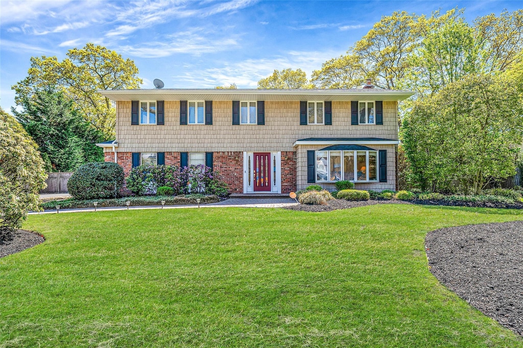 4 Victor Pl, Lake Grove, NY 11755 - view of front facade with brick siding and a front lawn