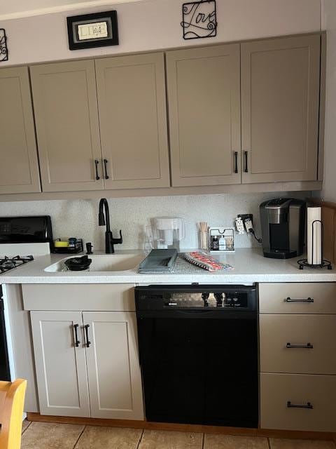 kitchen with light countertops, black dishwasher, white range with gas stovetop, gray cabinetry, and a sink