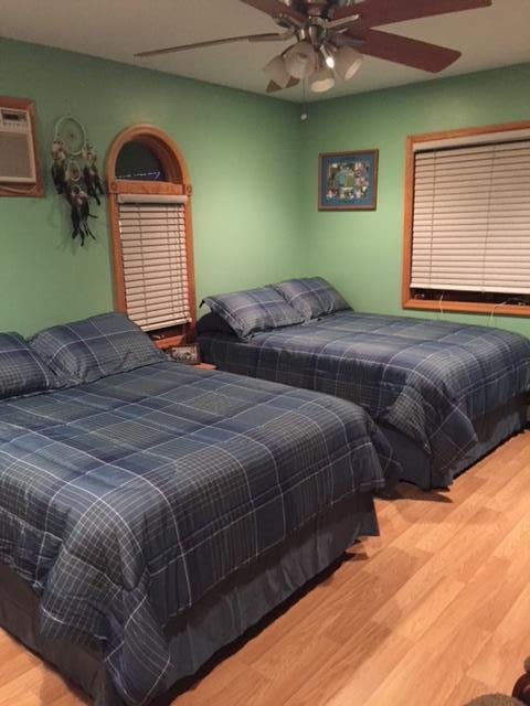 bedroom featuring wood finished floors and ceiling fan
