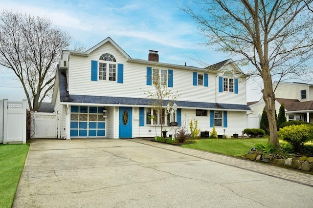 63 Bucket Ln, Levittown, NY 11756 - traditional home featuring a chimney, a gate, fence, a front lawn, and concrete driveway