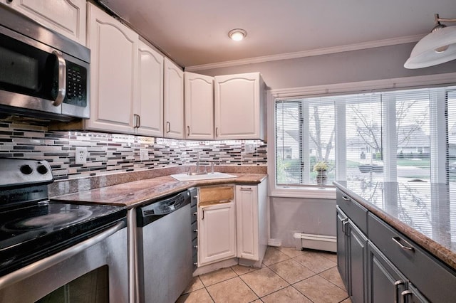 63 Bucket Ln, Levittown, NY 11756 - kitchen with a sink, light tile patterned floors, ornamental molding, appliances with stainless steel finishes, and a baseboard radiator