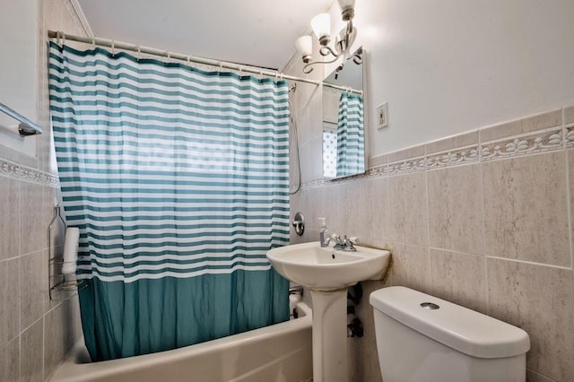 63 Bucket Ln, Levittown, NY 11756 - bathroom featuring tile walls, wainscoting, shower / bath combination with curtain, and toilet