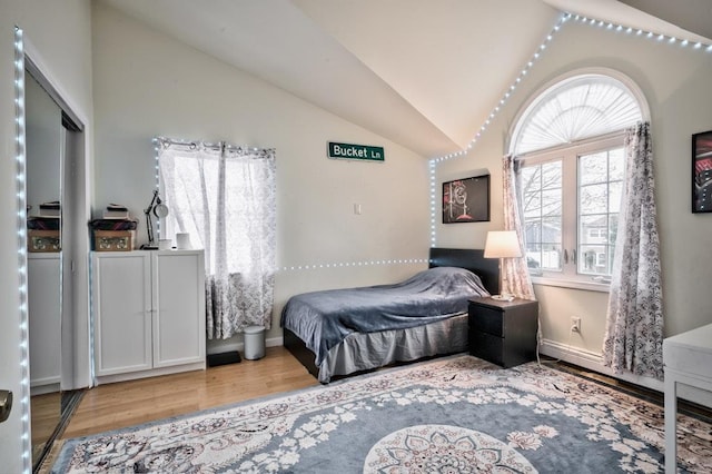 63 Bucket Ln, Levittown, NY 11756 - bedroom featuring wood finished floors, lofted ceiling, and baseboards