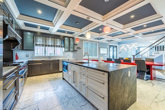 kitchen featuring marble finish floor, a sink, high end range, and glass insert cabinets
