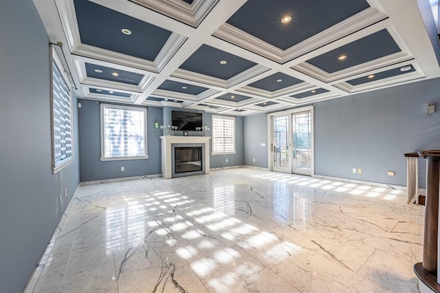 unfurnished living room featuring marble finish floor, a glass covered fireplace, baseboards, and coffered ceiling
