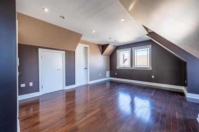 additional living space featuring baseboards, vaulted ceiling, recessed lighting, and hardwood / wood-style flooring