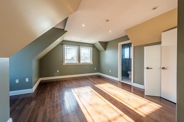 additional living space featuring baseboards, lofted ceiling, recessed lighting, and dark wood-type flooring