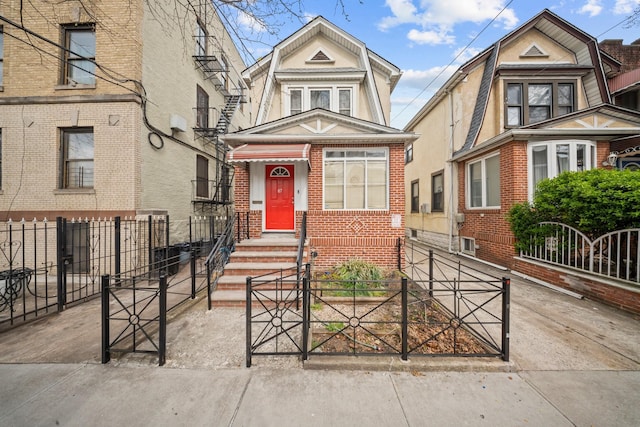 87 E 32nd St, Brooklyn, NY 11226 - colonial inspired home with a gate, entry steps, brick siding, and a fenced front yard