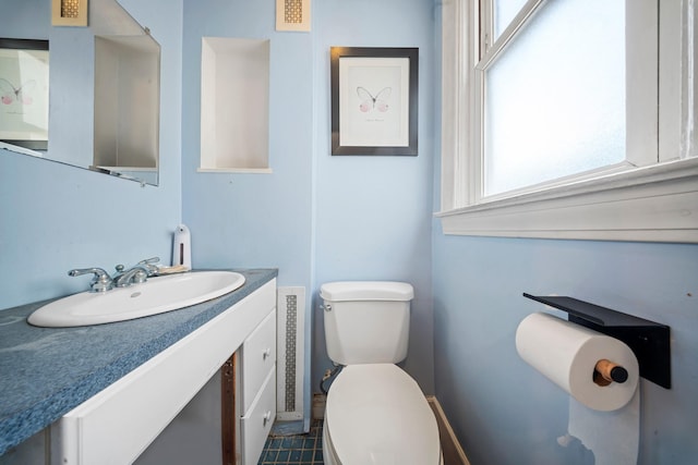 87 E 32nd St, Brooklyn, NY 11226 - half bath featuring visible vents, baseboards, vanity, and toilet