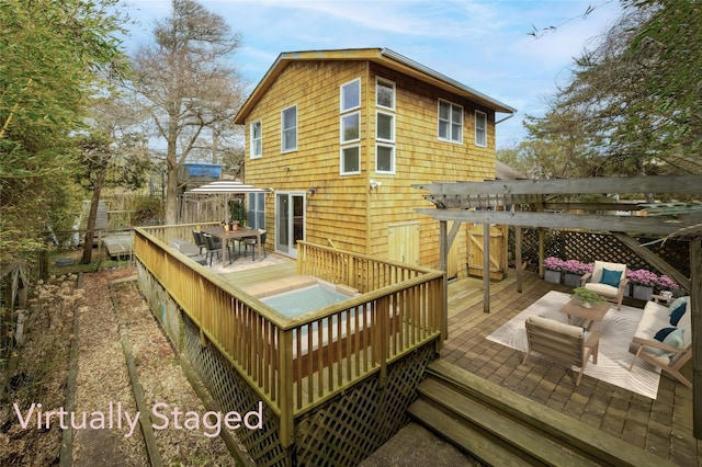 wooden deck with outdoor dining area, outdoor lounge area, and fence