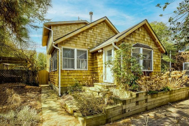view of front of home featuring fence