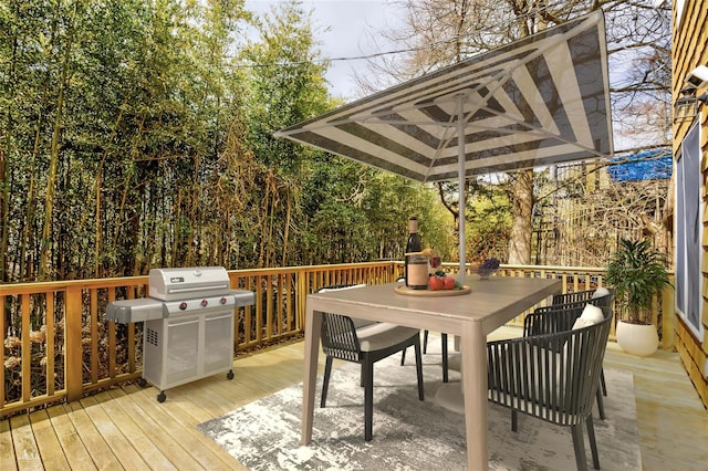 deck with grilling area and outdoor dining area