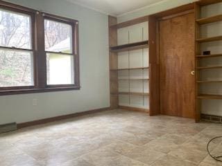 29 S Plank Rd, Westtown, NY 10998 - spare room featuring baseboards, stone finish flooring, and a healthy amount of sunlight