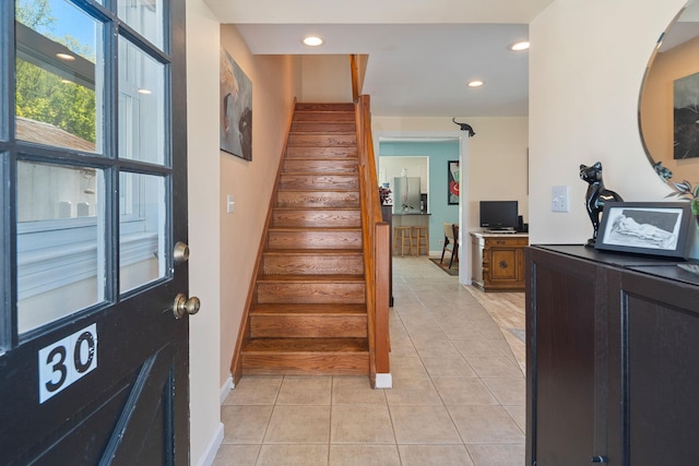 foyer featuring stairs, recessed lighting, baseboards, and light tile patterned floors