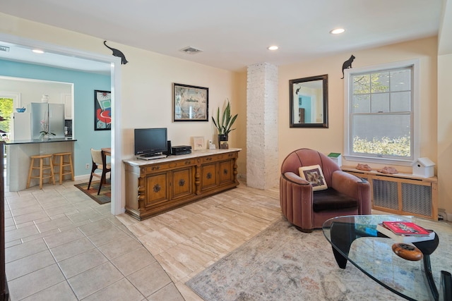 sitting room with a healthy amount of sunlight, recessed lighting, light tile patterned flooring, and visible vents