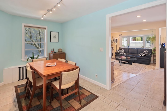 dining area with light tile patterned floors, baseboards, recessed lighting, and rail lighting