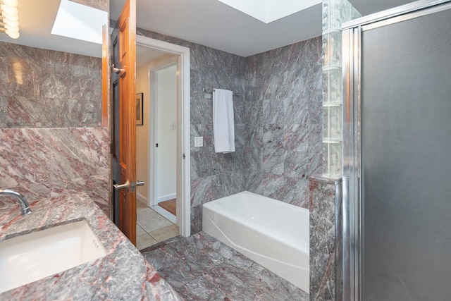 full bathroom with a garden tub, a sink, a shower with door, and double vanity