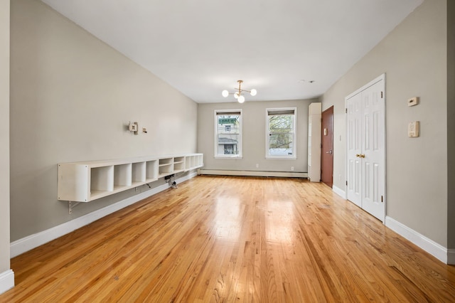 338 Hendrix St, Brooklyn, NY 11207 - unfurnished living room featuring a baseboard radiator, light wood-type flooring, baseboards, and an inviting chandelier