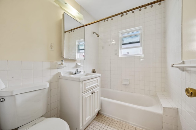 338 Hendrix St, Brooklyn, NY 11207 - full bath featuring tile patterned floors, vanity, tub / shower combination, tile walls, and toilet