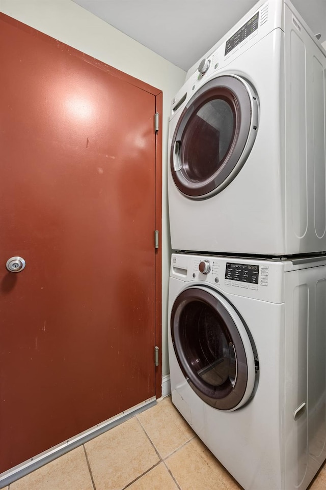 338 Hendrix St, Brooklyn, NY 11207 - laundry room with stacked washer / dryer, laundry area, and light tile patterned floors