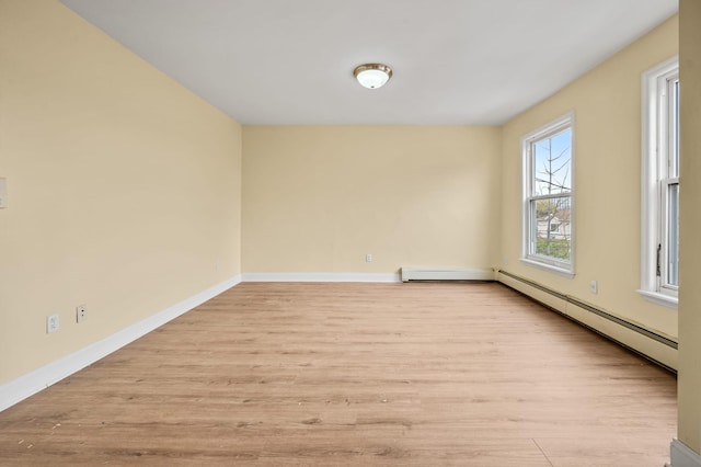338 Hendrix St, Brooklyn, NY 11207 - spare room featuring a baseboard heating unit, wood finished floors, and baseboards