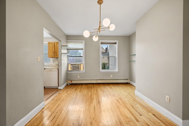 338 Hendrix St, Brooklyn, NY 11207 - unfurnished dining area featuring baseboard heating, baseboards, a chandelier, and light wood finished floors