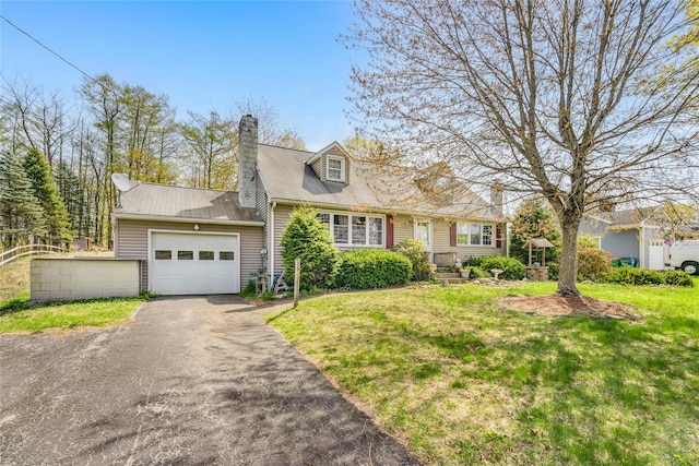 cape cod-style house with a chimney, a front lawn, driveway, and an attached garage