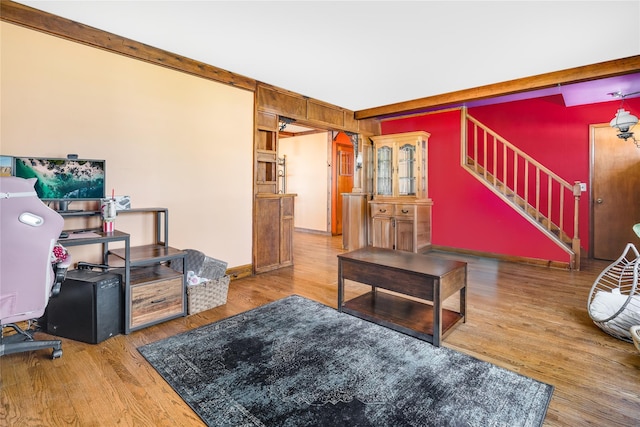 living area featuring stairs and wood finished floors