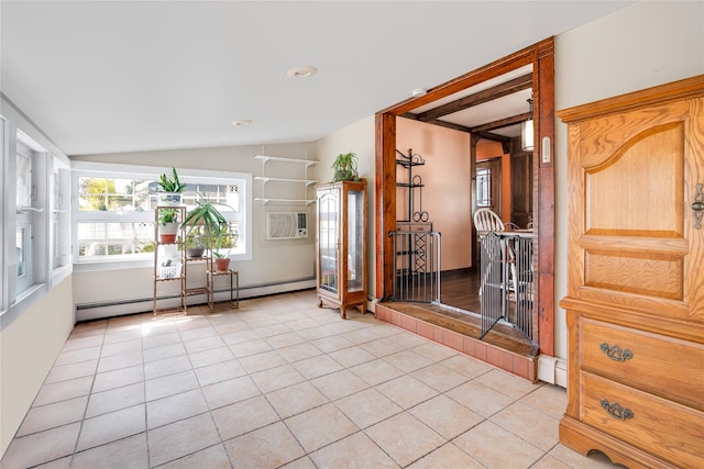 interior space with lofted ceiling, light tile patterned floors, and a baseboard heating unit