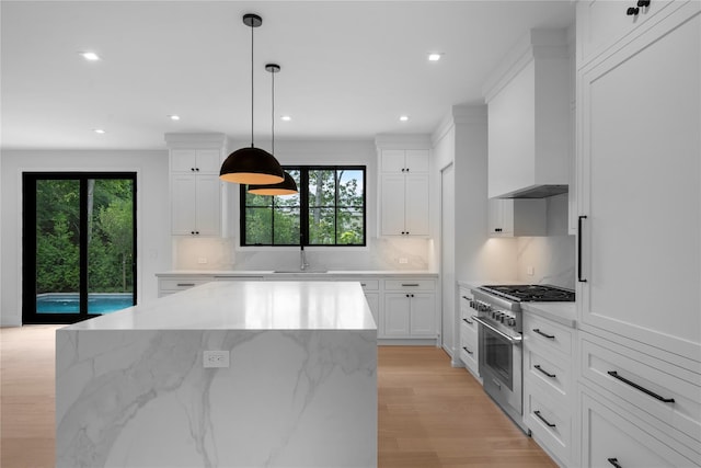 466 Montauk Hwy, Westhampton Beach, NY 11978 - kitchen with high end stove, decorative backsplash, white cabinets, plenty of natural light, and recessed lighting