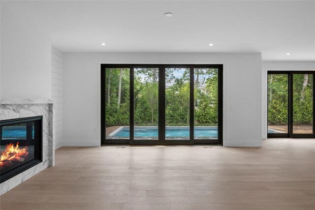 466 Montauk Hwy, Westhampton Beach, NY 11978 - unfurnished living room with wood finished floors, a fireplace, and recessed lighting