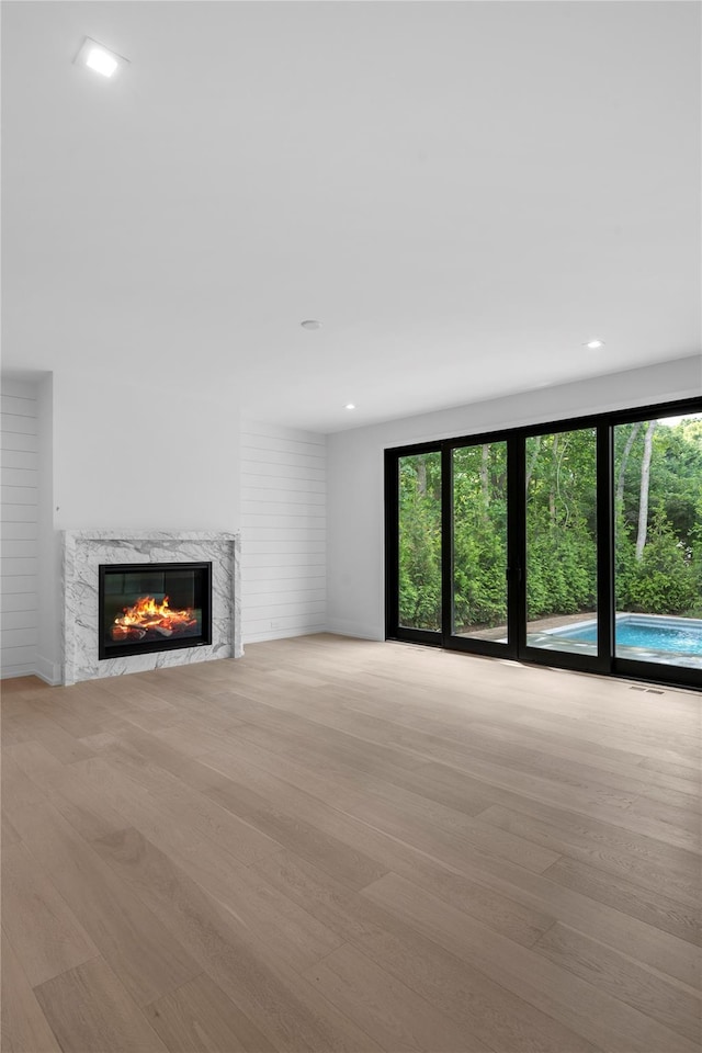 466 Montauk Hwy, Westhampton Beach, NY 11978 - unfurnished living room with wood finished floors, a high end fireplace, and recessed lighting