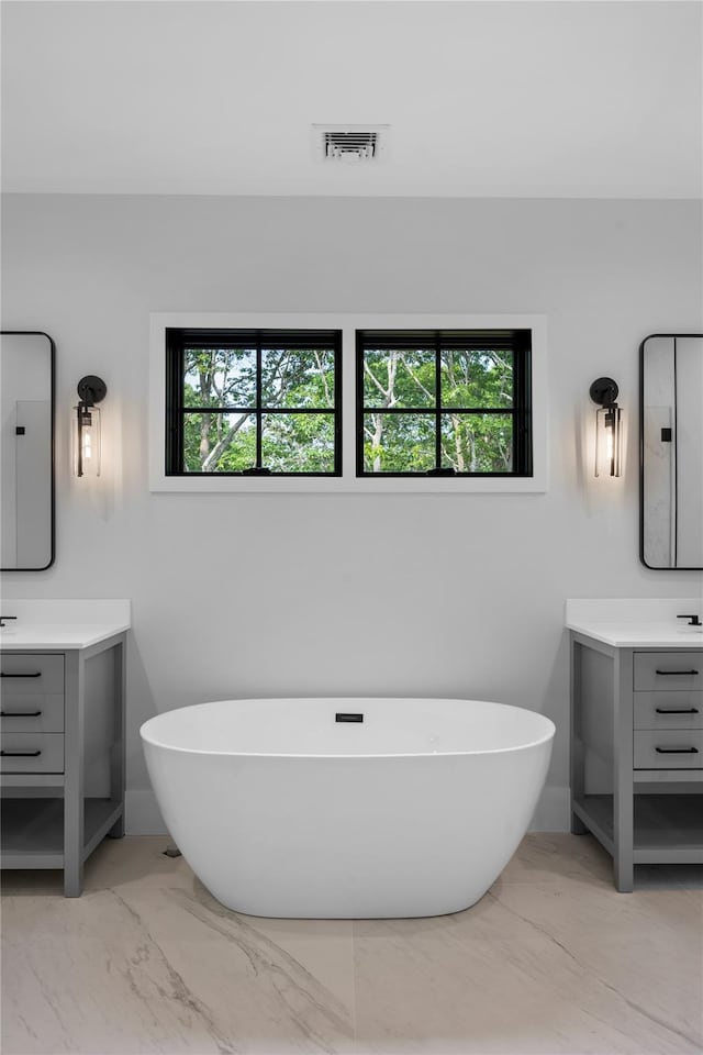 466 Montauk Hwy, Westhampton Beach, NY 11978 - full bathroom featuring vanity, a soaking tub, and marble finish flooring
