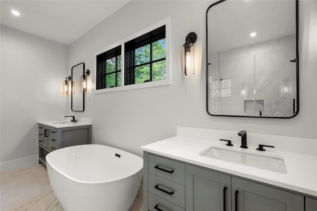 466 Montauk Hwy, Westhampton Beach, NY 11978 - bathroom featuring vanity, a freestanding tub, a marble finish shower, and recessed lighting